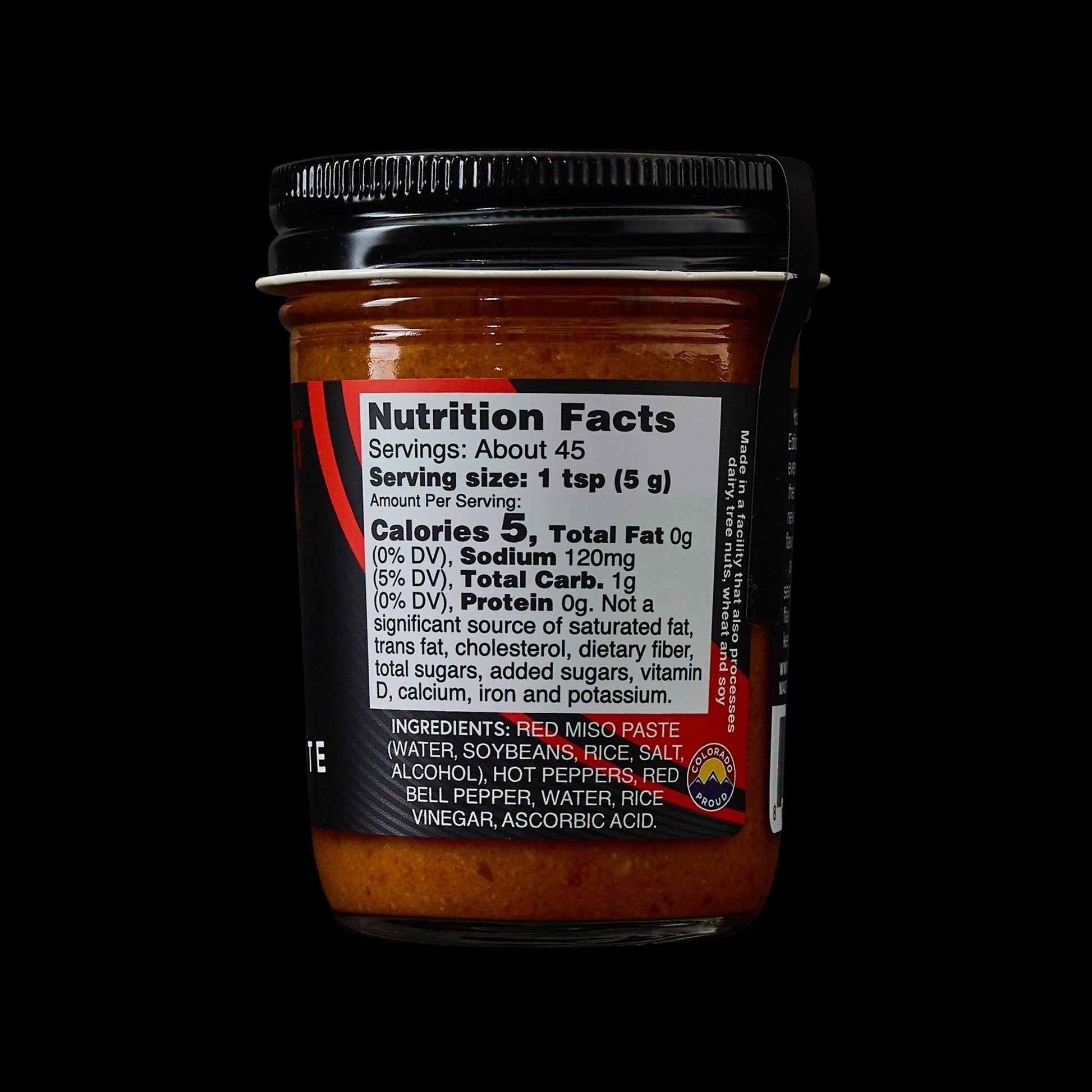 MisoHeat Chili Paste 8oz jar back view, with the nutrition label and a black background