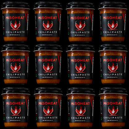 Twelve (12) jars of MisoHeat Chili Paste 8z stacked to represent a case of MisoHeat